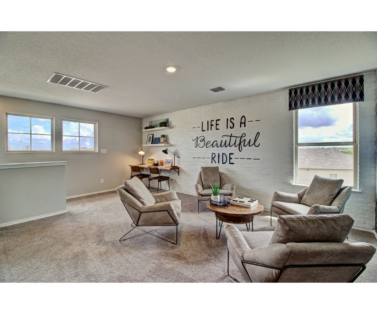 A living room with a couch and chairs.