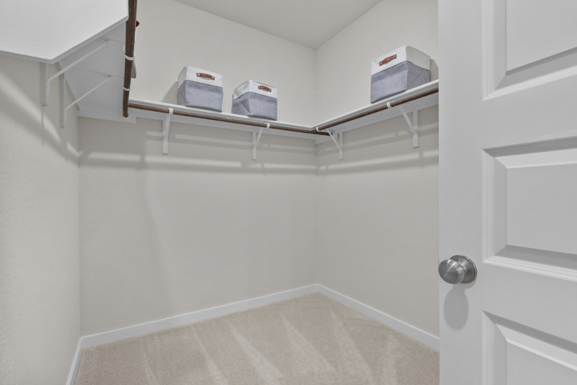 A white shelf with boxes on it.