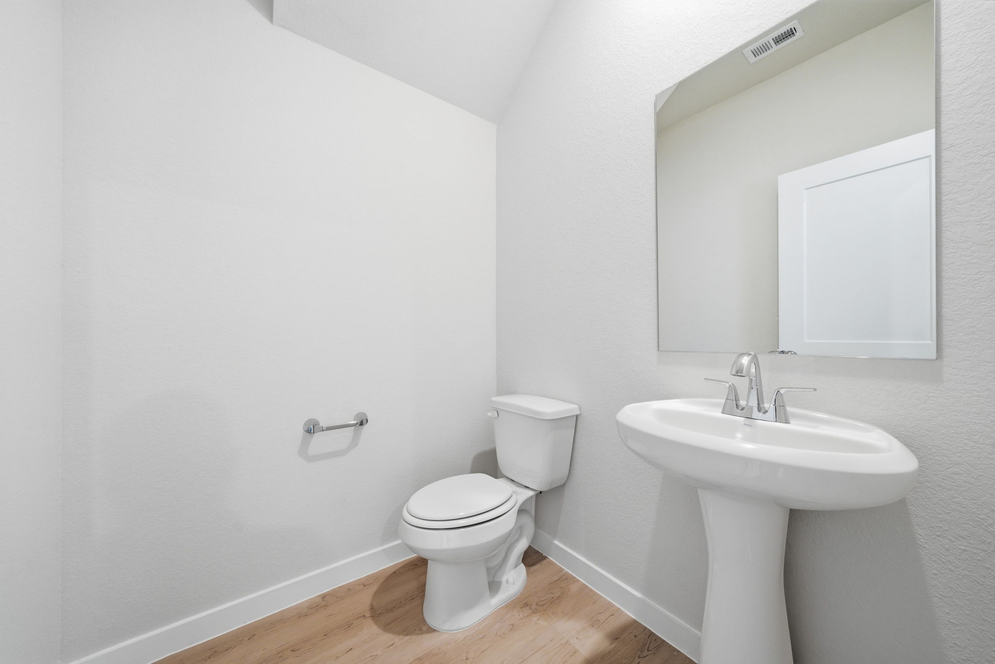 A bathroom with a toilet and sink.
