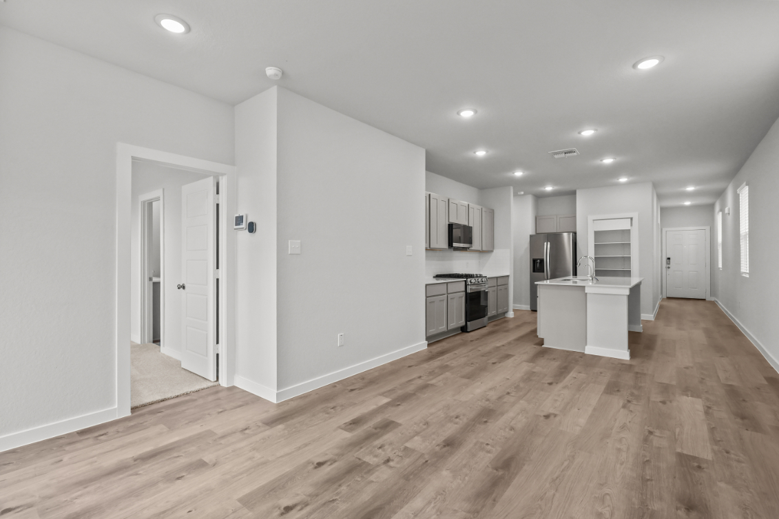 A large kitchen with white walls.