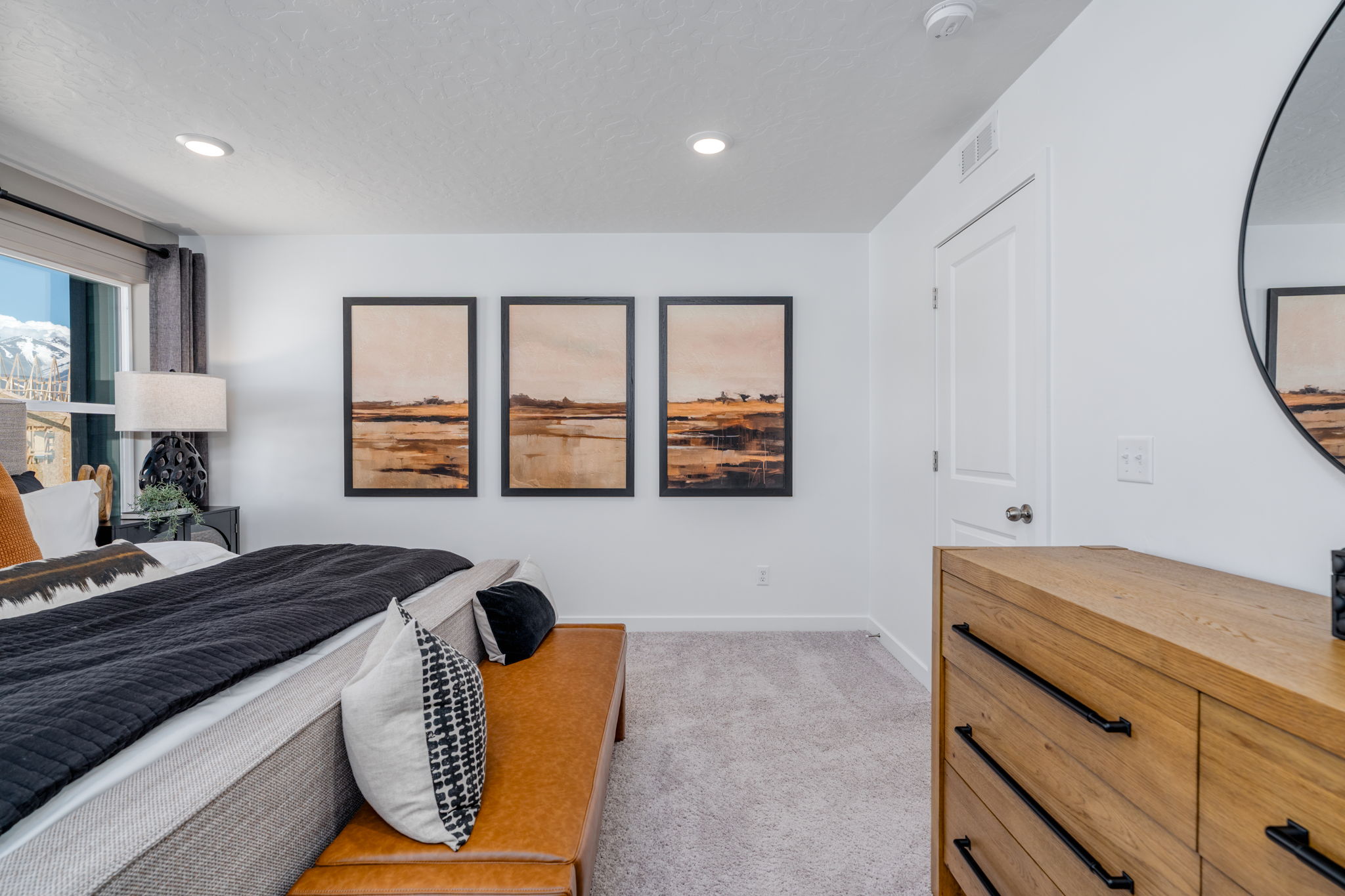 A bedroom with a bed and a dresser.