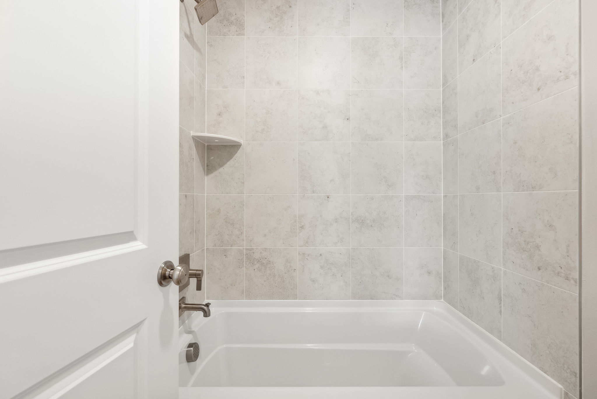 A bathtub in a bathroom.