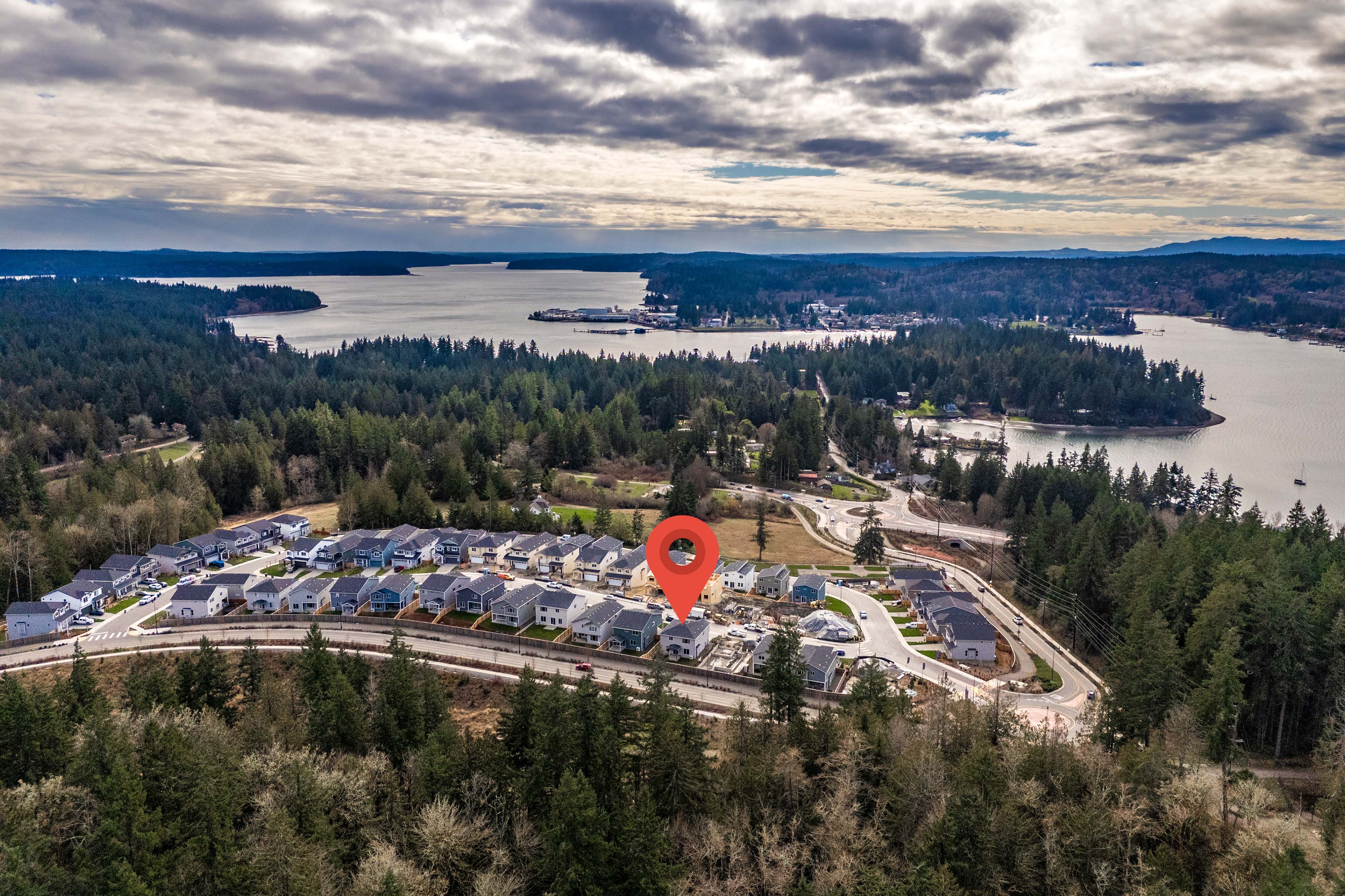 A parking lot with a large red balloon in the middle of a parking lot with a body of.