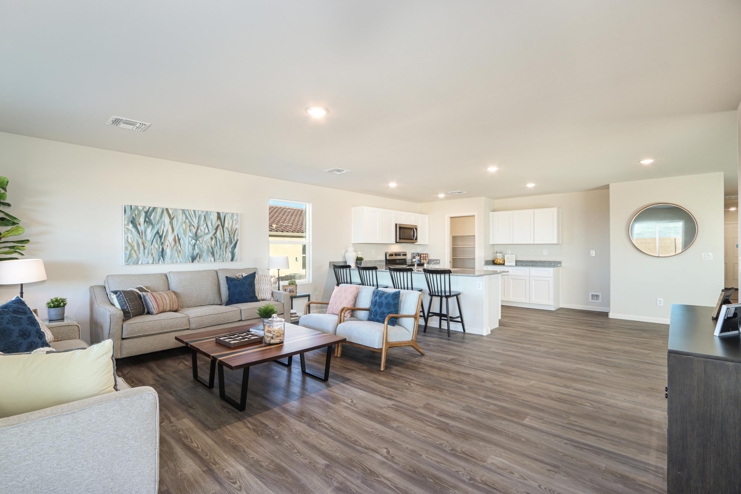 A large living room with a wood floor.