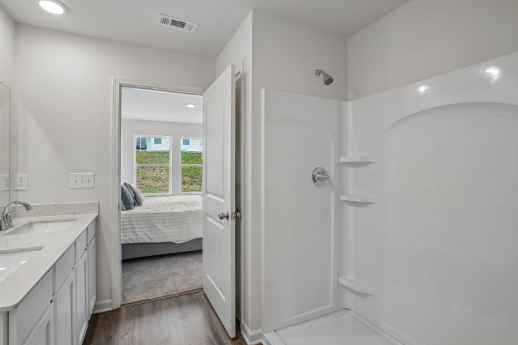 A bathroom with a bed and sink.