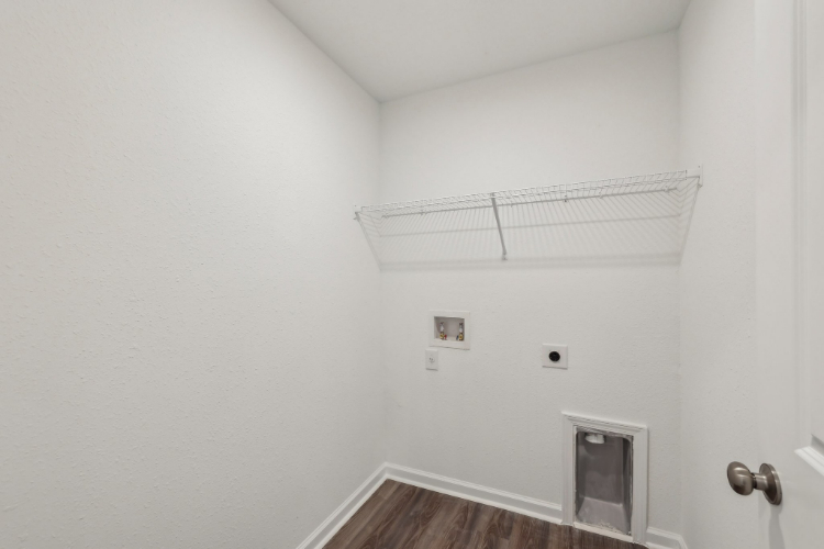 A room with a vent and a wood floor.