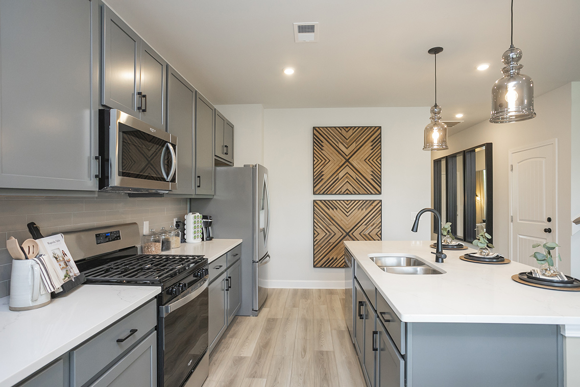 A kitchen with white cabinets.