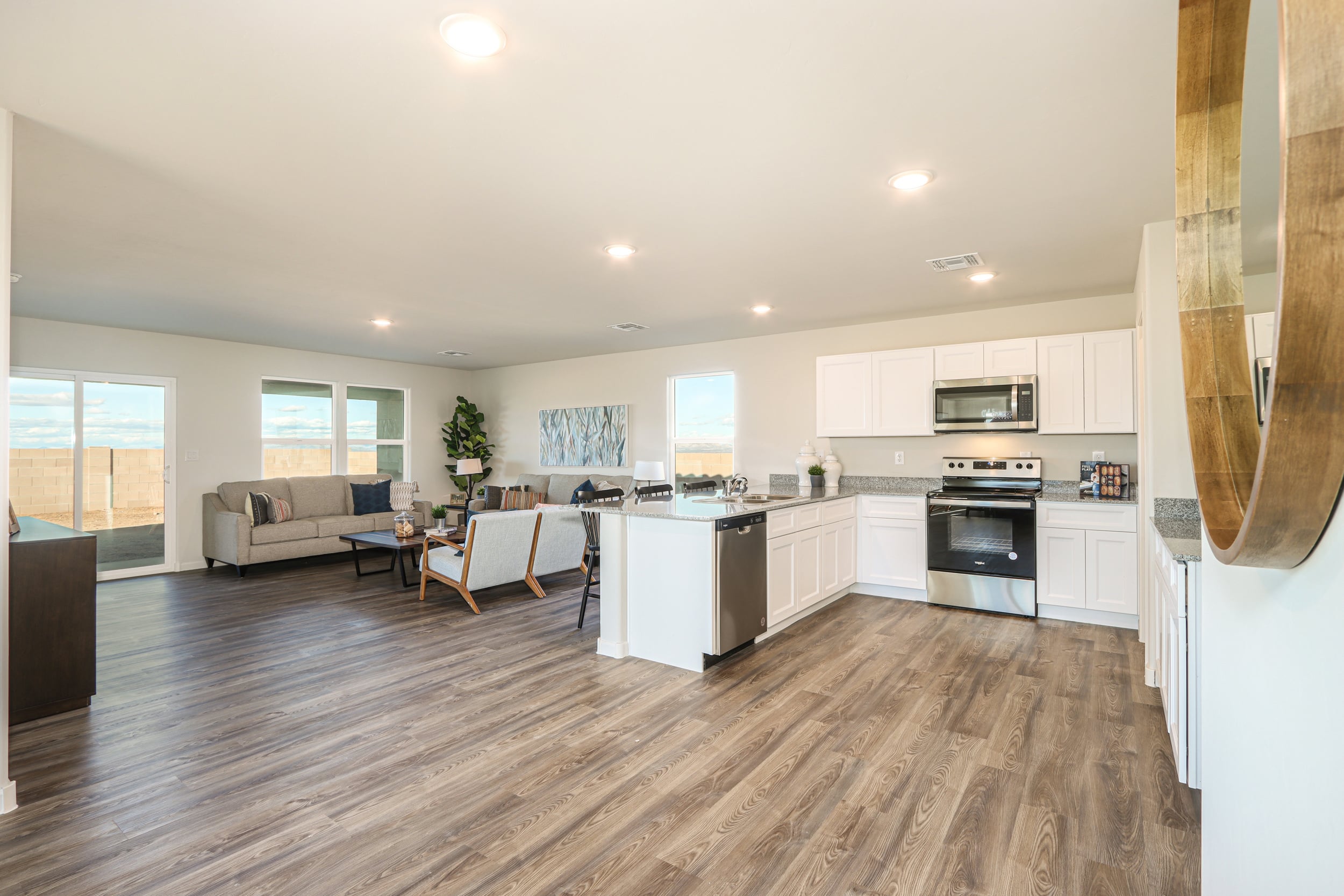 A large kitchen with a wood floor.