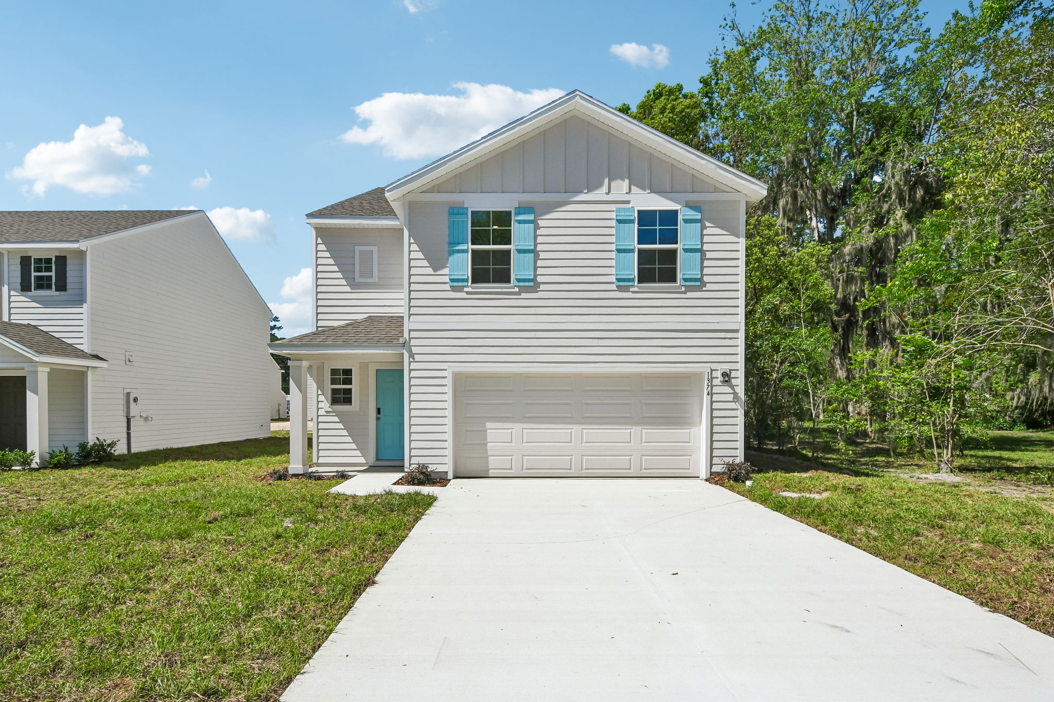 A white house with a garage.