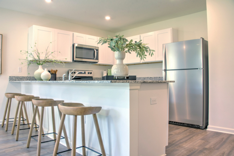 A kitchen with a table and stools.