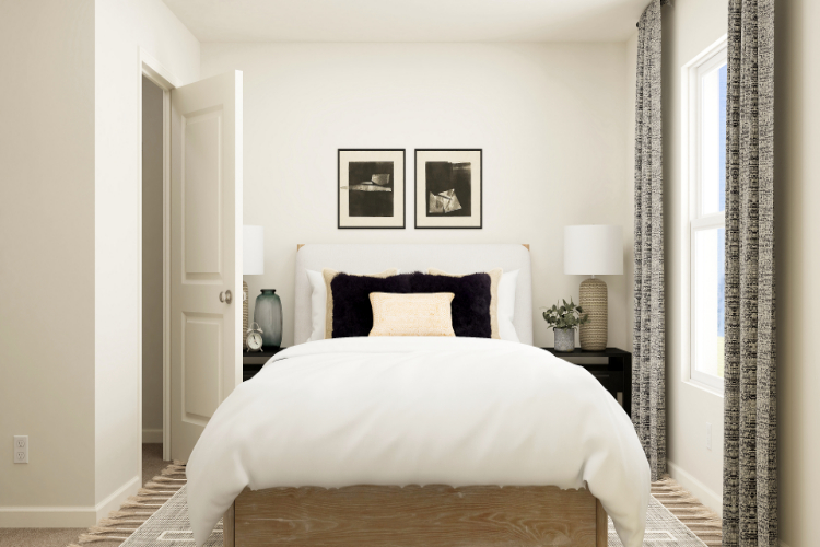 A bedroom with a bed and lamps.