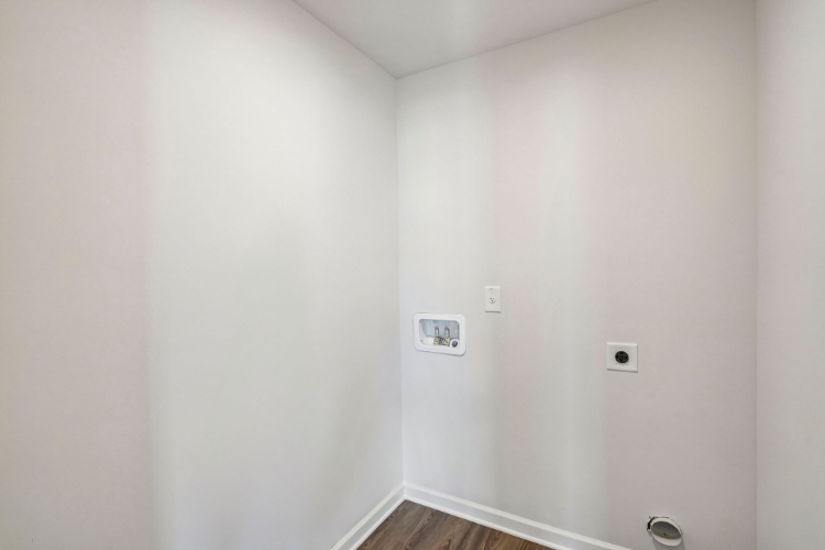 A white wall with a light switch.
