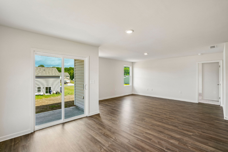 A room with a wood floor and white walls.