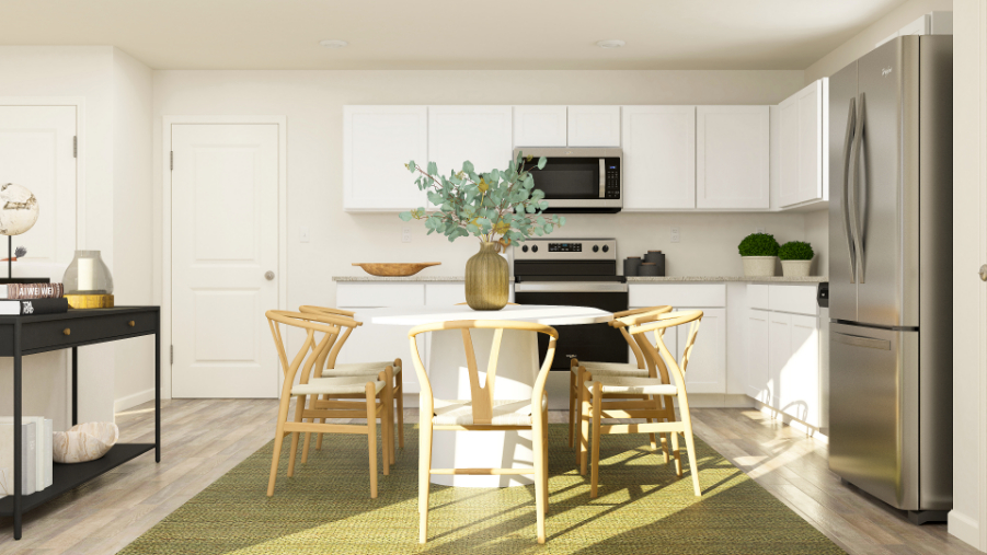 A kitchen with a table and chairs.