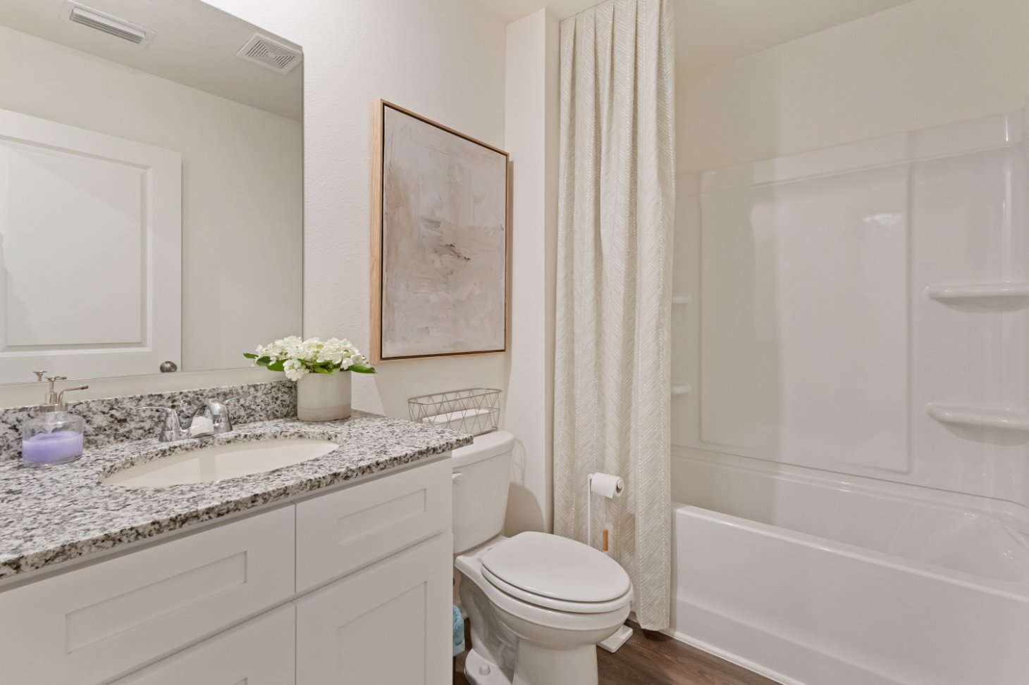 A bathroom with a tub sink and toilet.