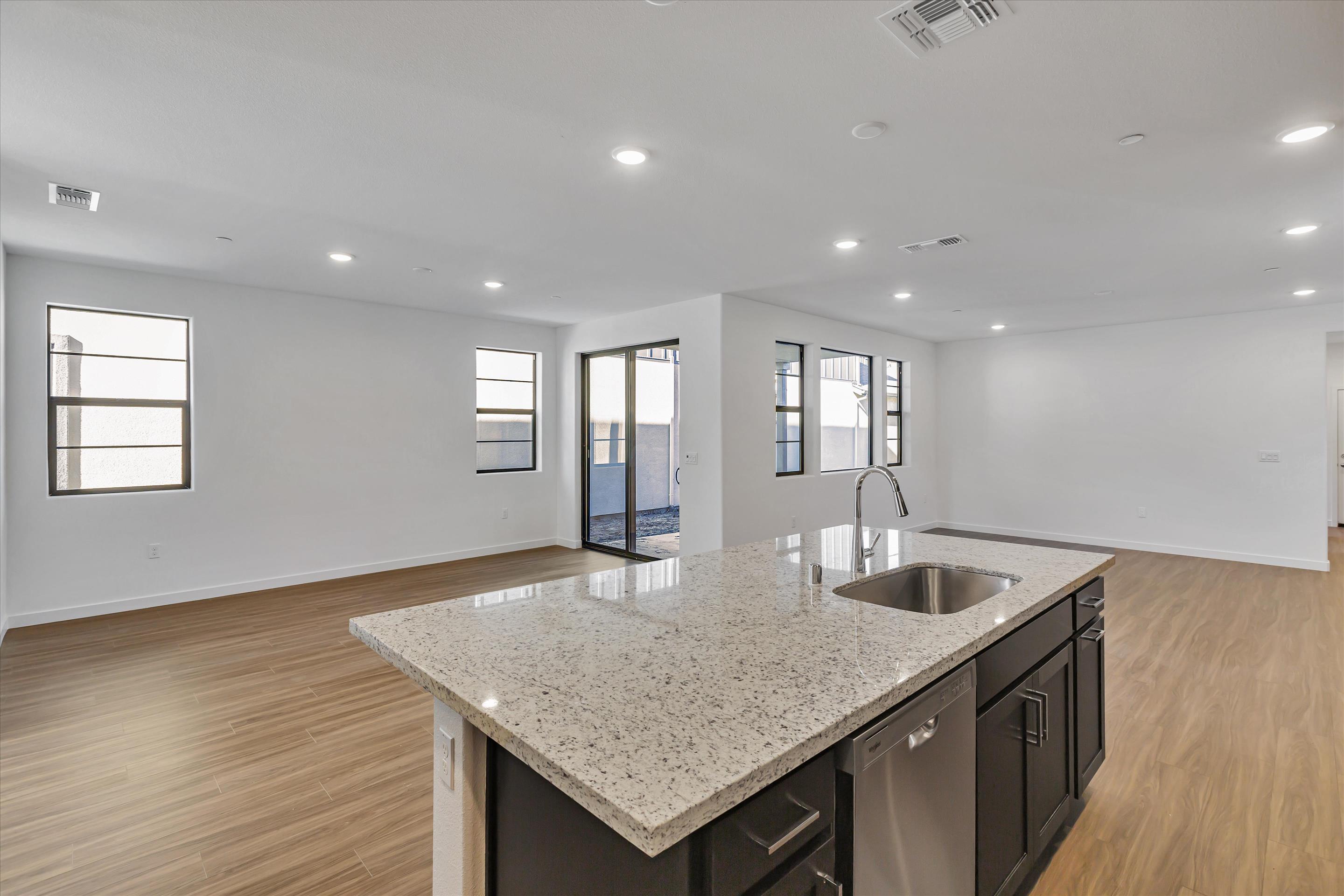 A kitchen with a marble countertop.