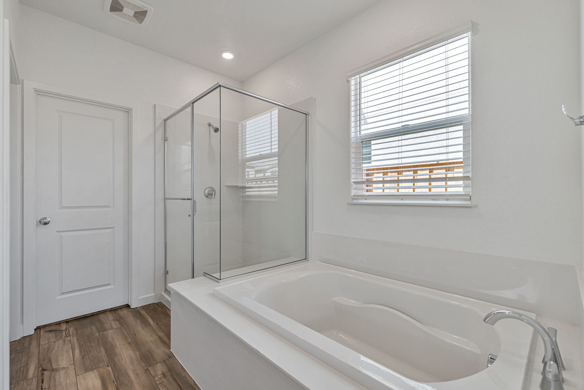 A bathroom with a tub and shower.